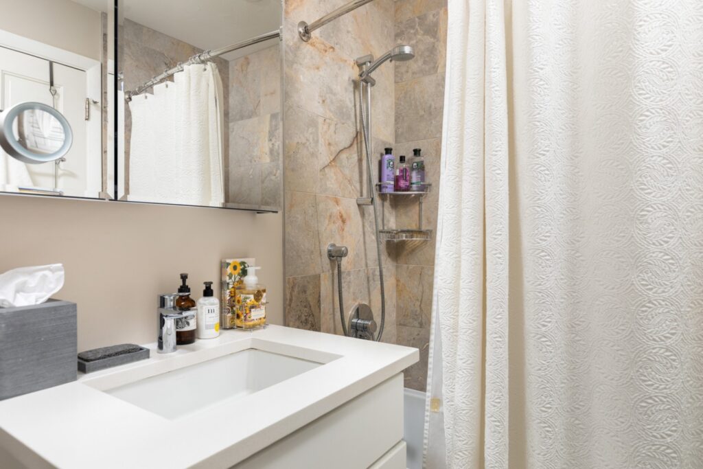 Modern bathroom with shower and white vanity.