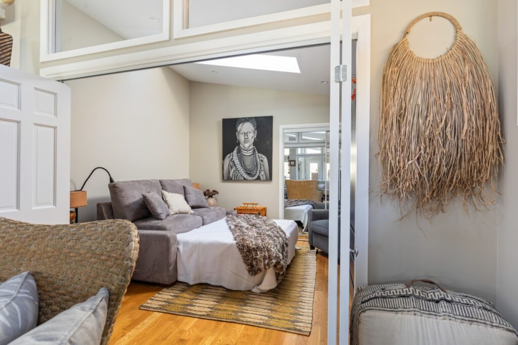 Cozy bedroom with gray sofa bed and decor