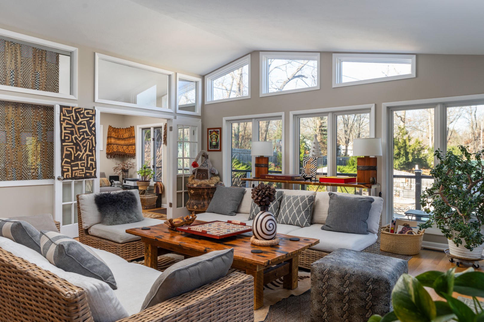 Bright living room with wicker furniture and large windows