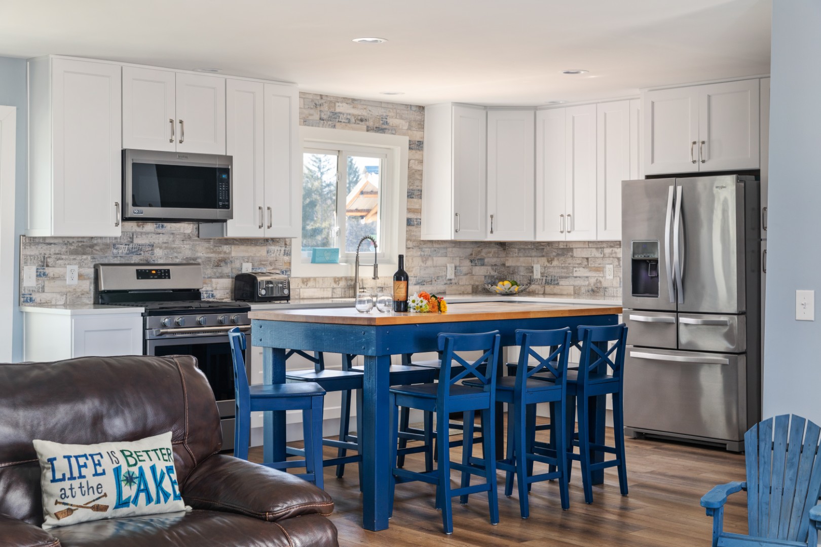 Modern kitchen with blue island and white cabinets