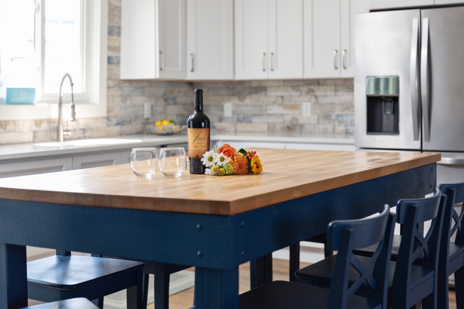 Modern kitchen with wine and flowers on island