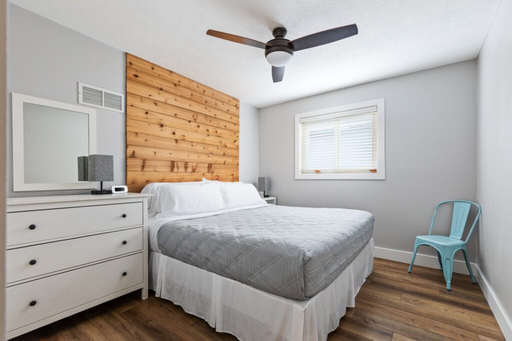 Modern bedroom with wooden accent wall