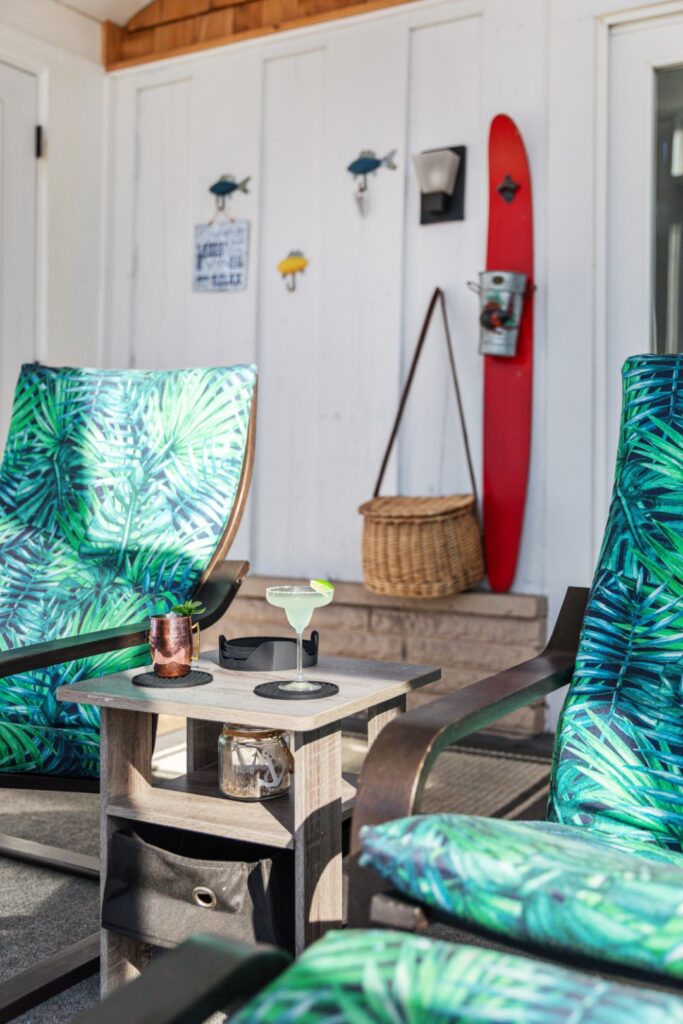 Outdoor patio chairs with tropical cushions and drinks