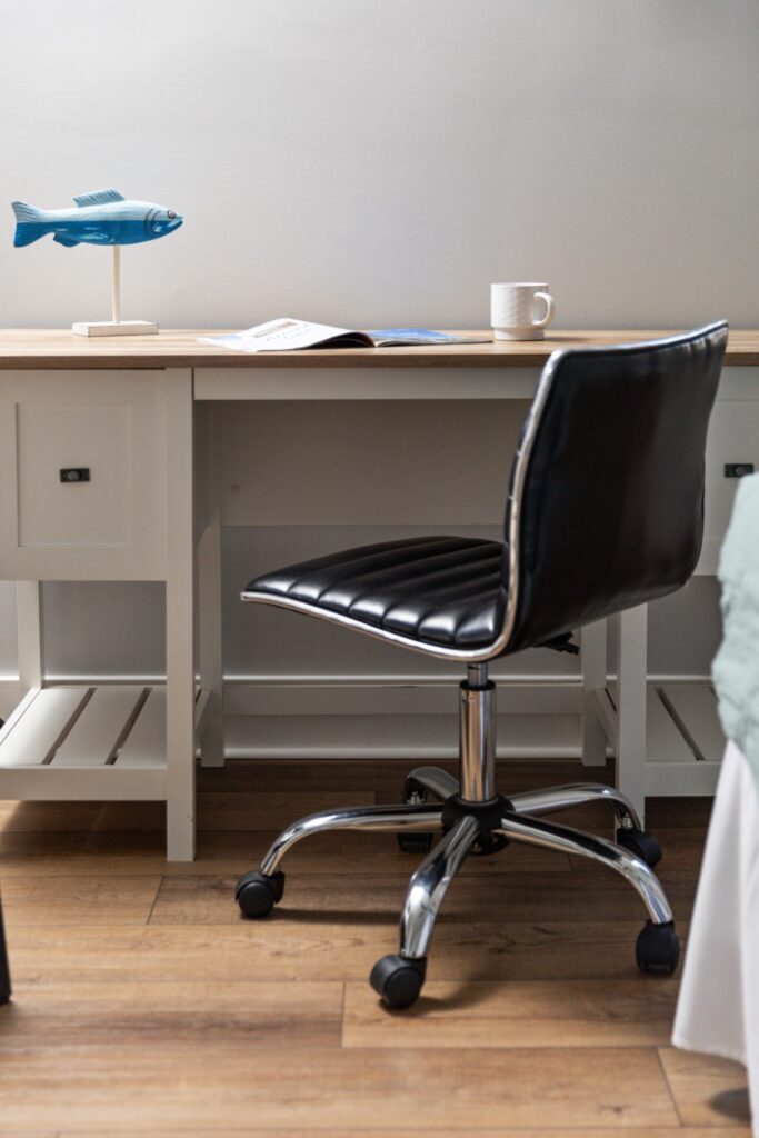 Home office desk with chair and coffee mug