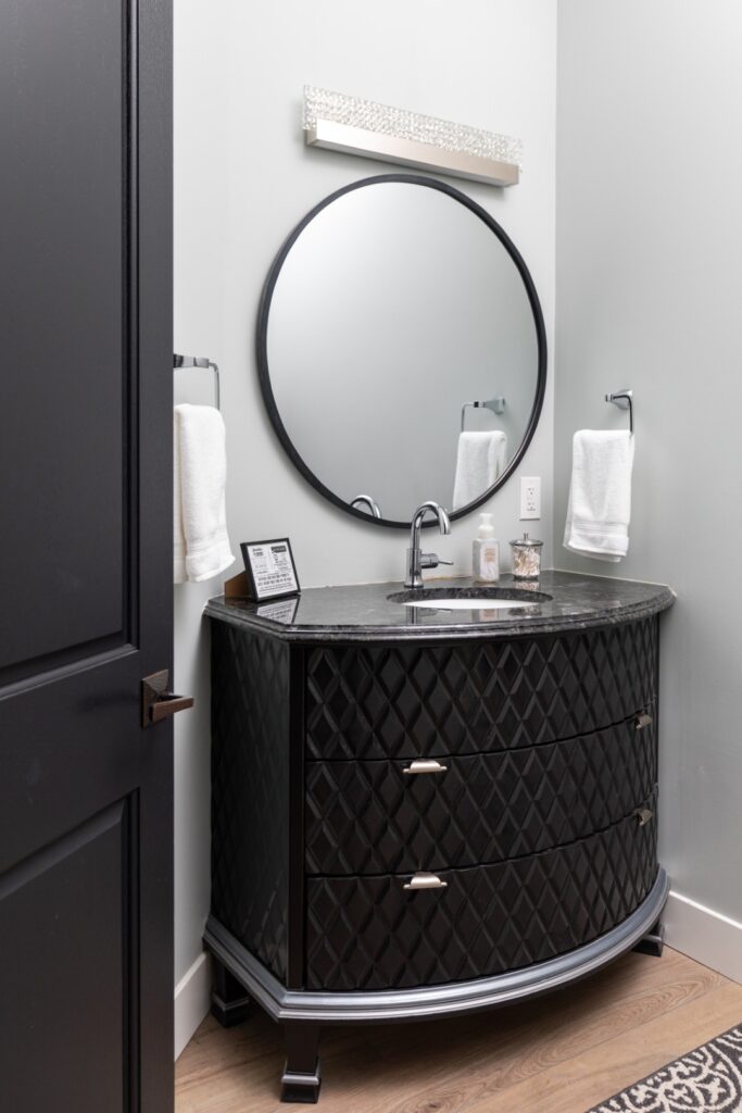 Modern bathroom vanity with round mirror and sink