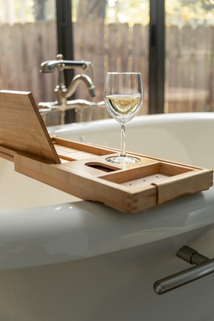 Glass of wine on bathtub tray