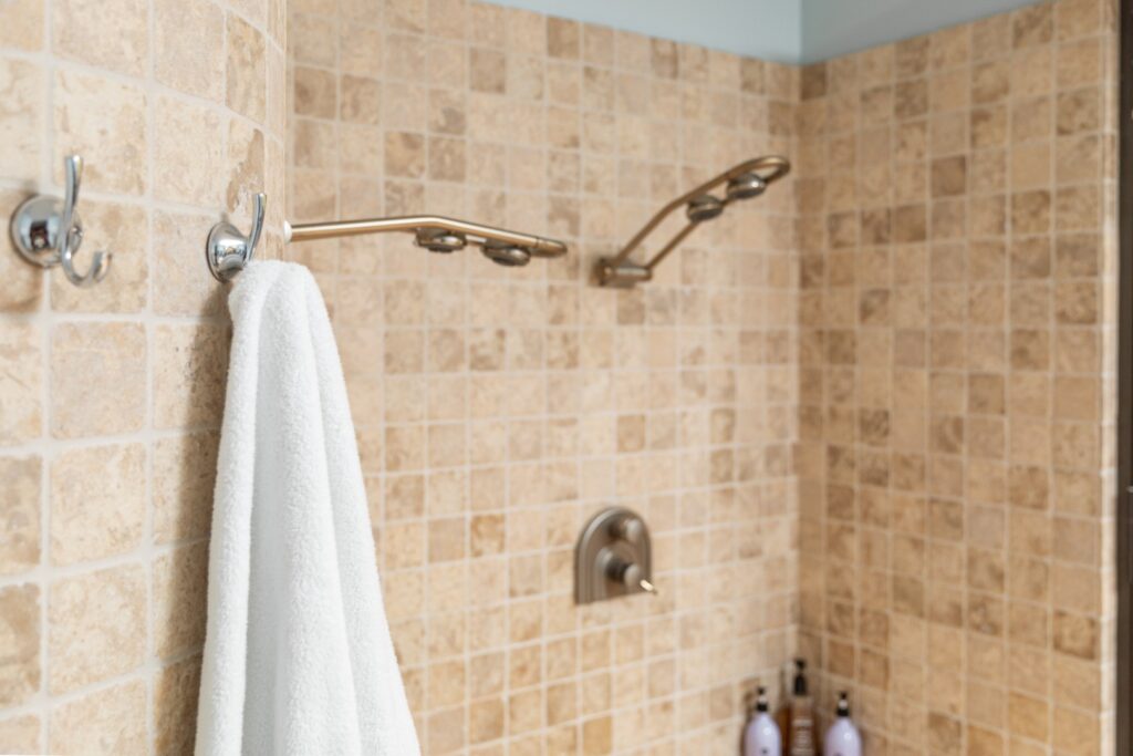 Modern tiled shower with towel and faucets