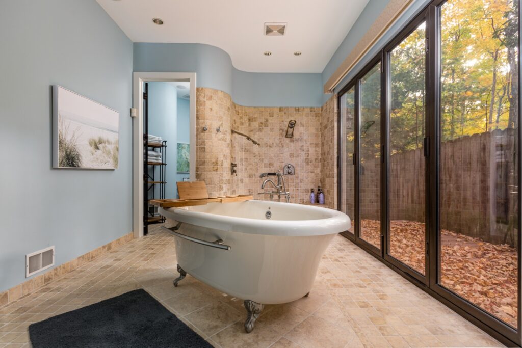 Modern bathroom with freestanding tub and large windows
