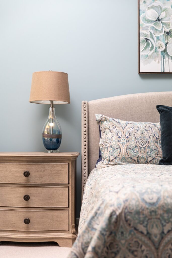 Cozy bedroom with lamp and patterned bedding