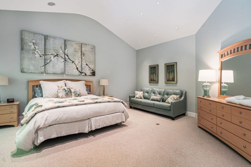 Modern bedroom with bed, sofa, and dresser