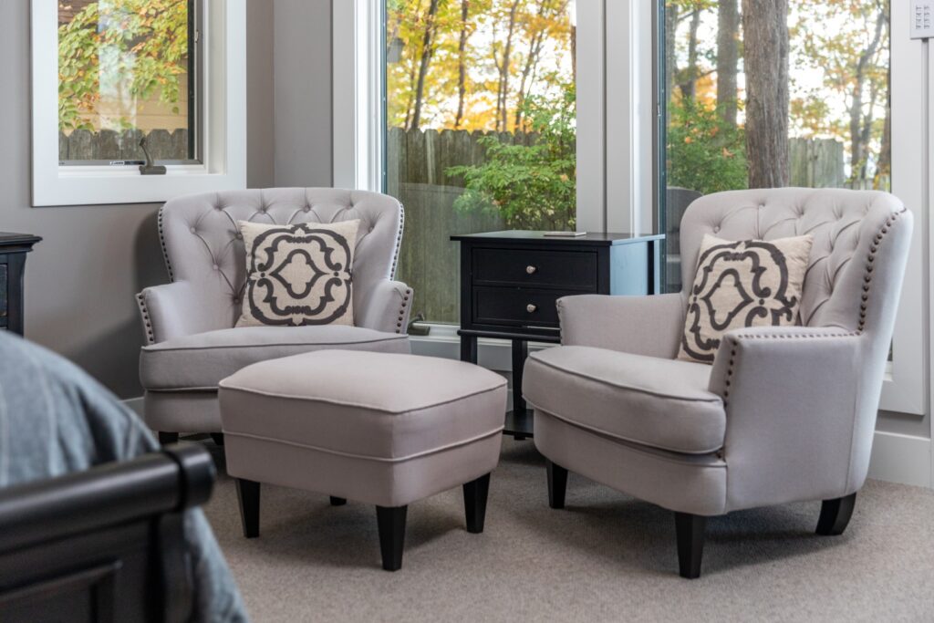 Cozy gray armchairs with ottoman in living room