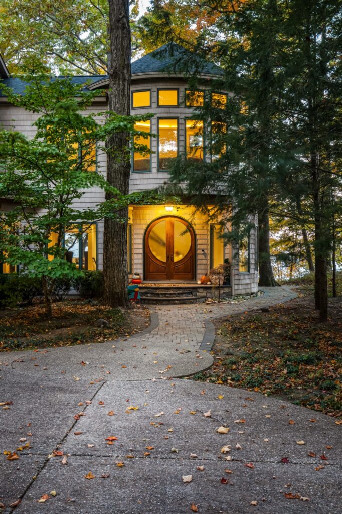 Modern house entrance surrounded by autumn trees