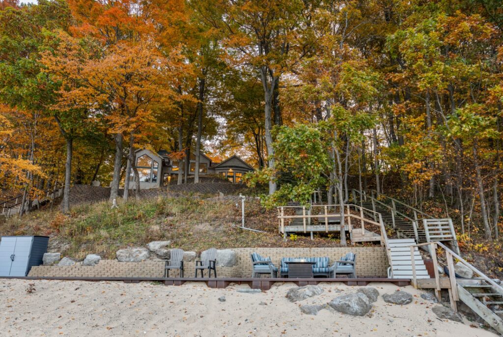 Lakefront house surrounded by colorful autumn trees