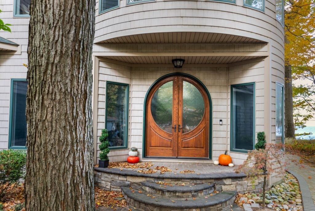 Wooden double door entrance with pumpkins