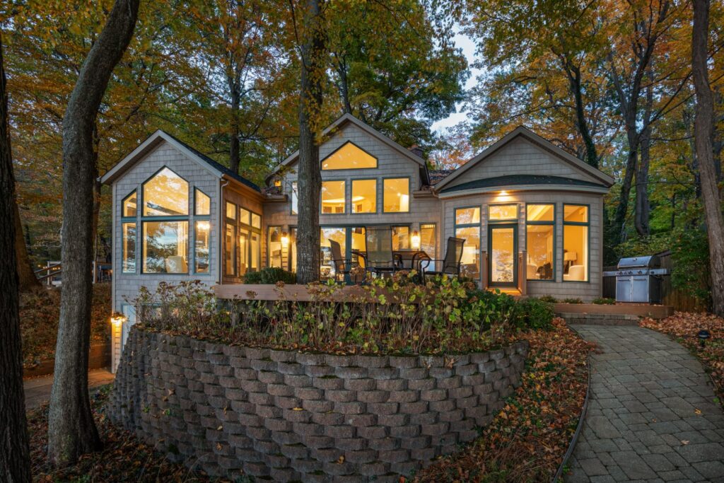 Modern house with large windows in autumn woods