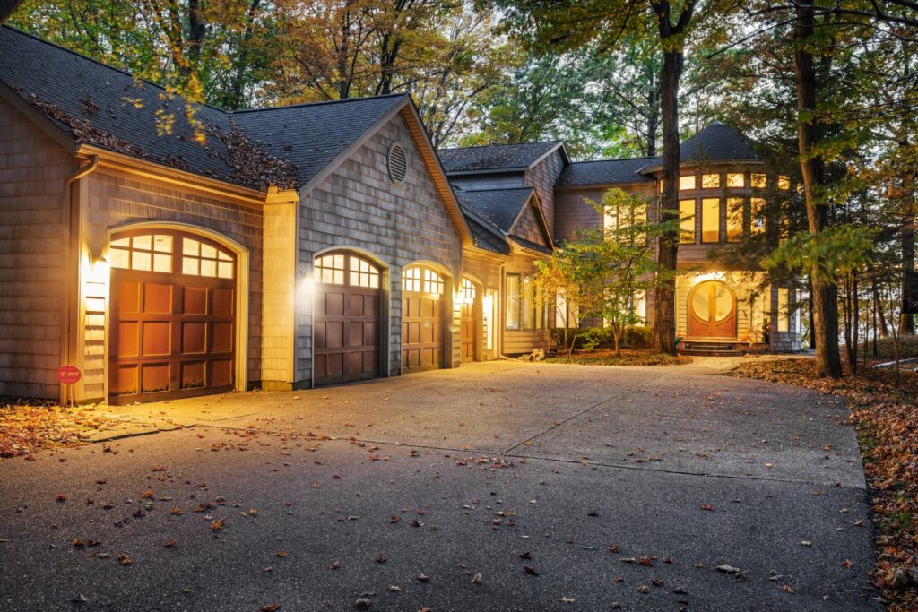 Modern house exterior with three-car garage at dusk