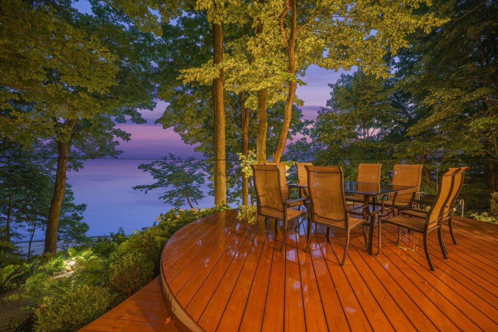 Deck with chairs overlooking lake at sunset