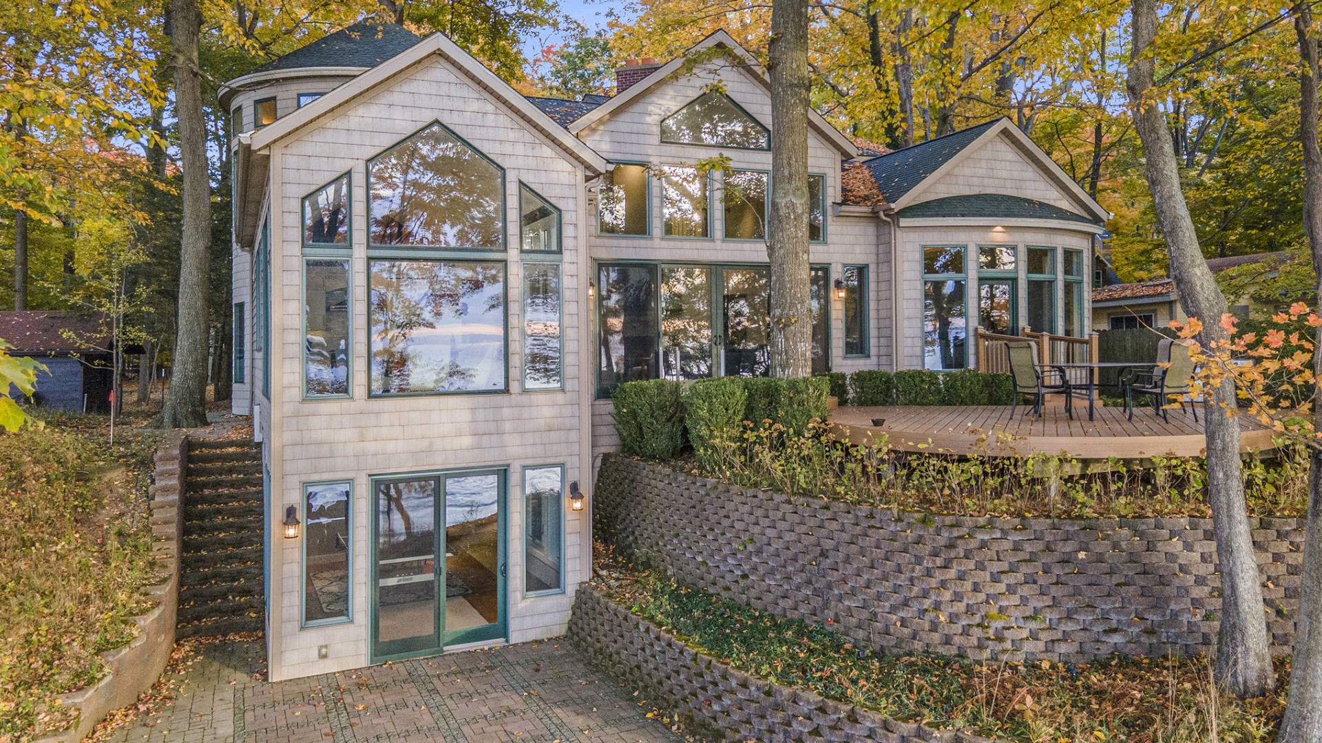 Modern lakefront house with large windows and patio