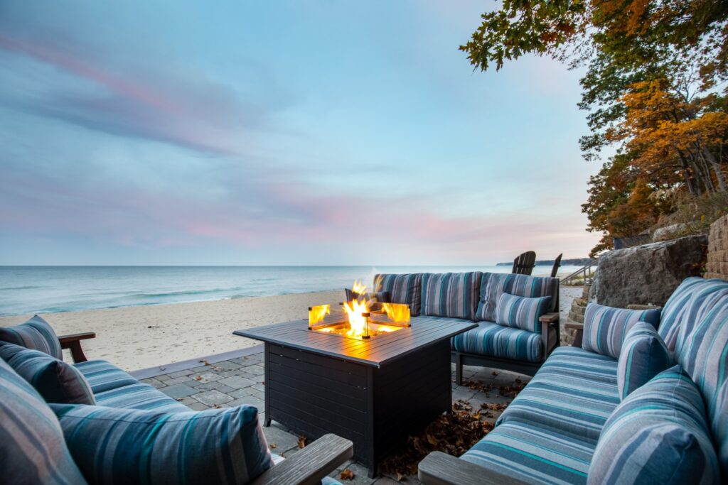 Beachfront patio with fire pit at sunset