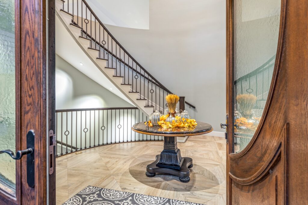 Elegant foyer with spiral staircase and round table