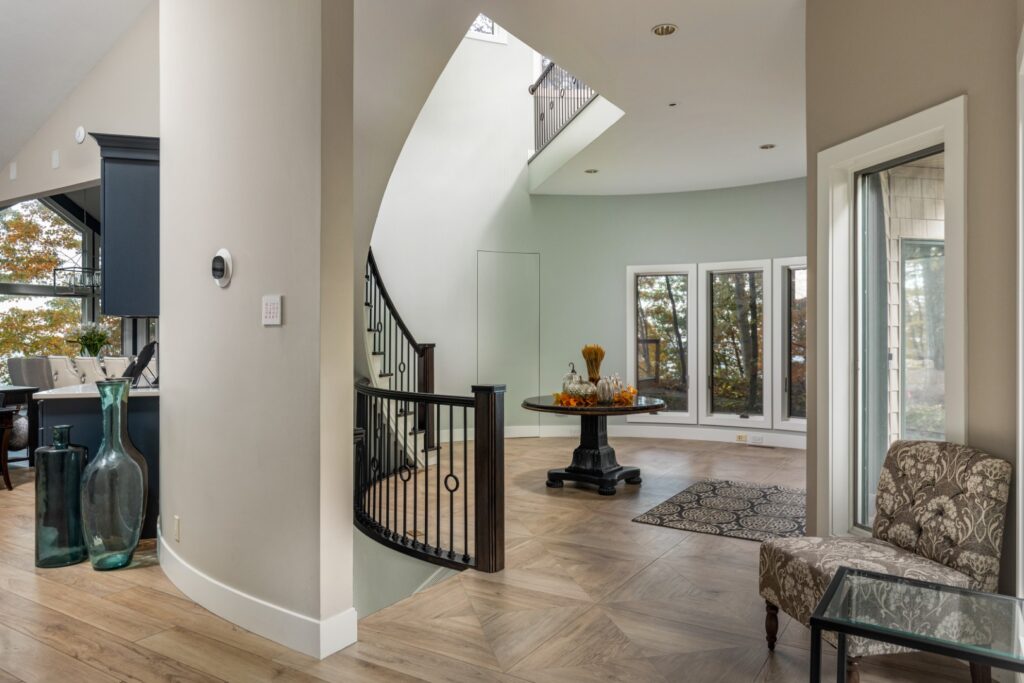 Modern home interior with staircase and large windows