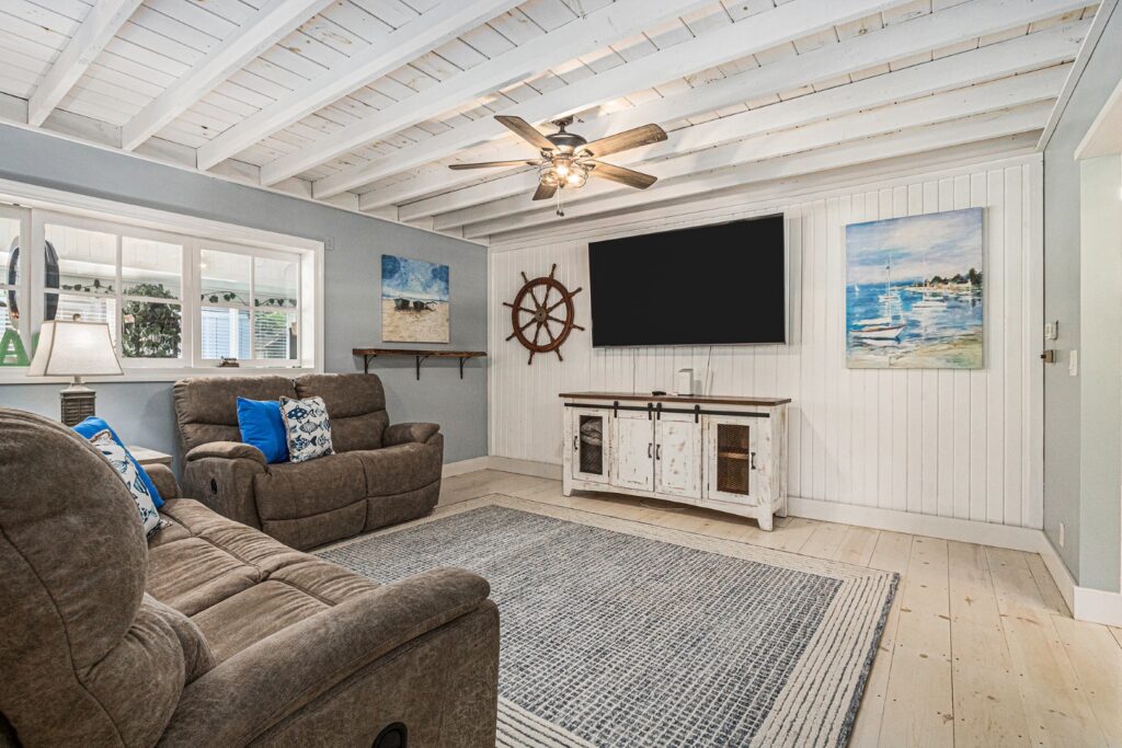 Coastal living room with rustic decor and TV