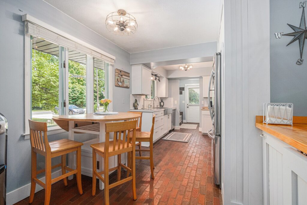 Bright kitchen with wooden dining table and chairs