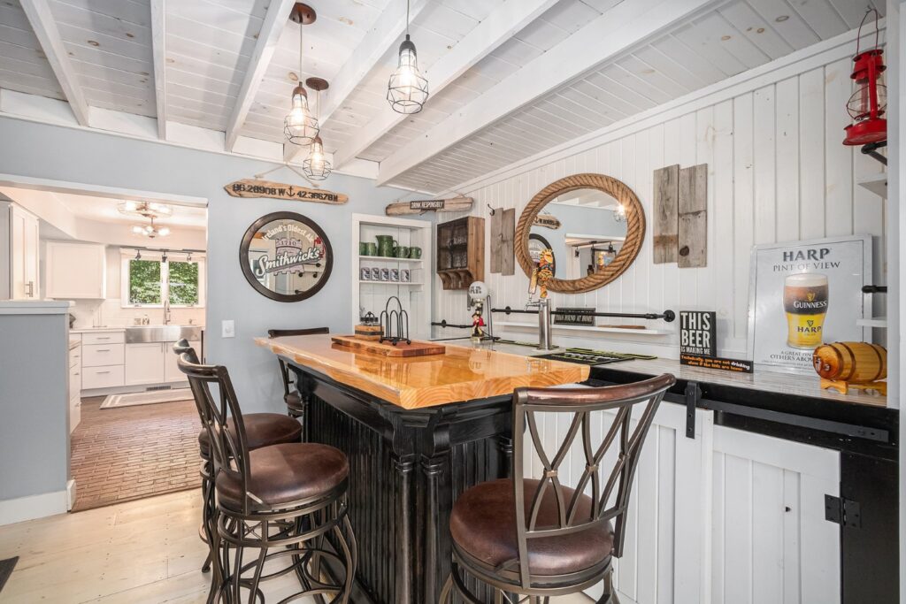 Cozy home bar with wooden counter and stools