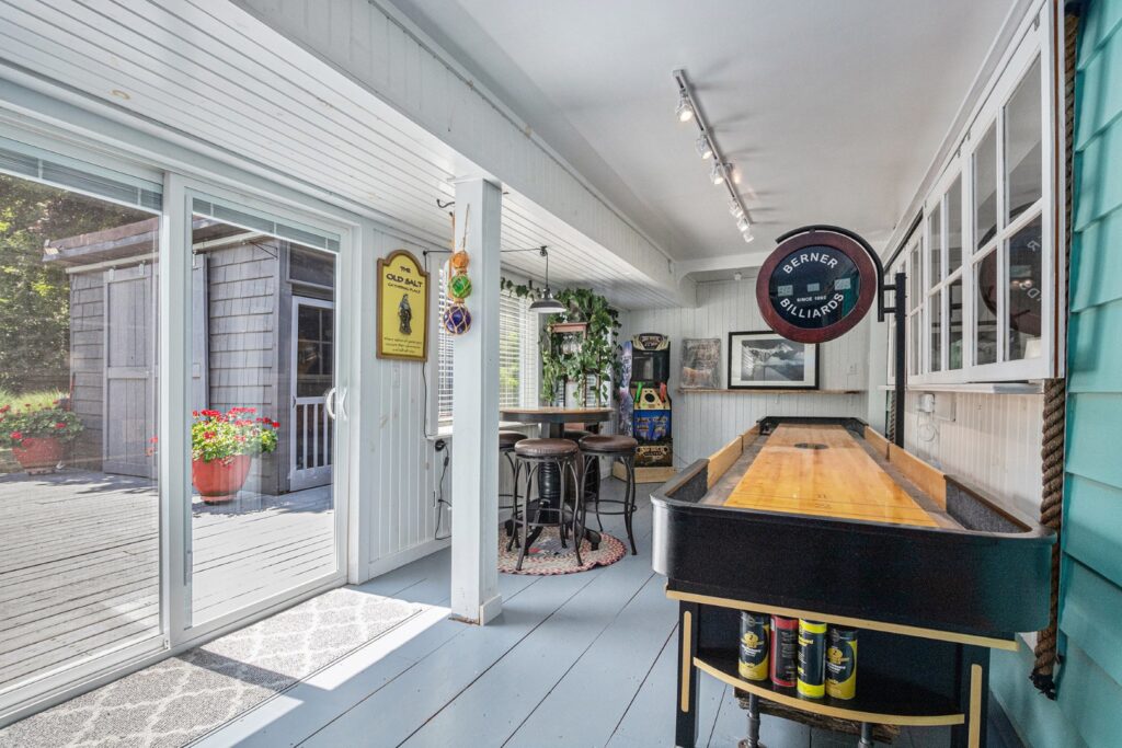 Sunroom with shuffleboard and patio access
