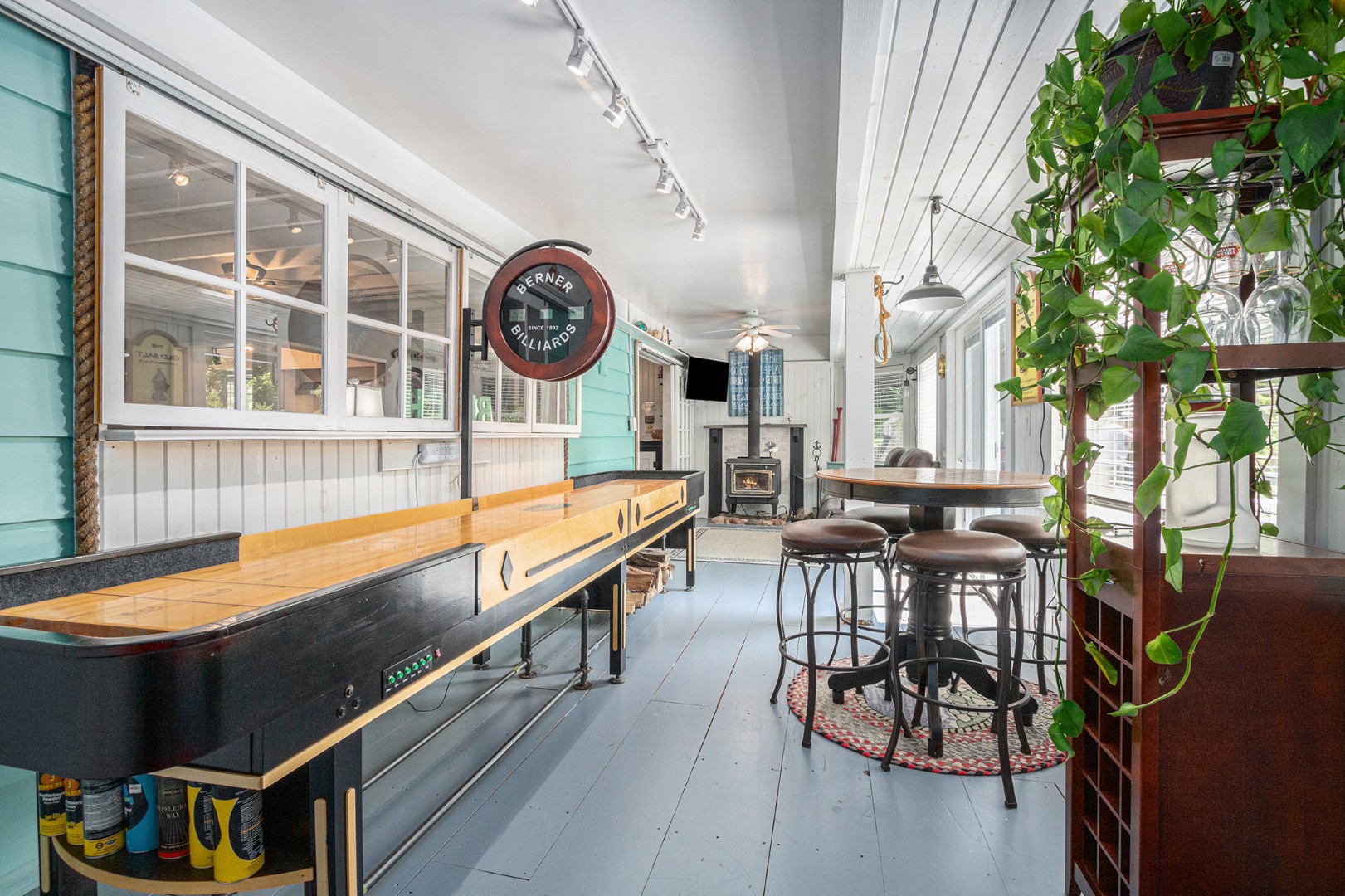 Cozy game room with shuffleboard and fireplace