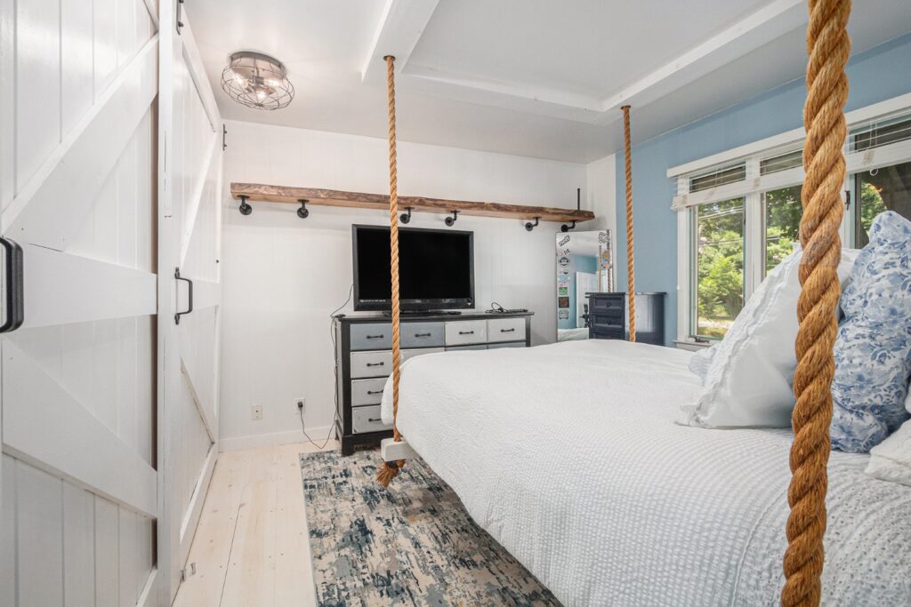 Cozy bedroom with rope-suspended bed and dresser