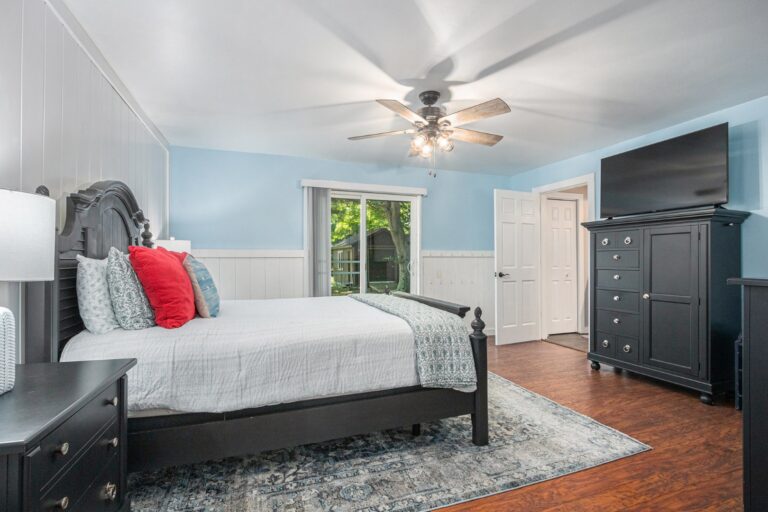 Bright bedroom with blue walls and black furniture