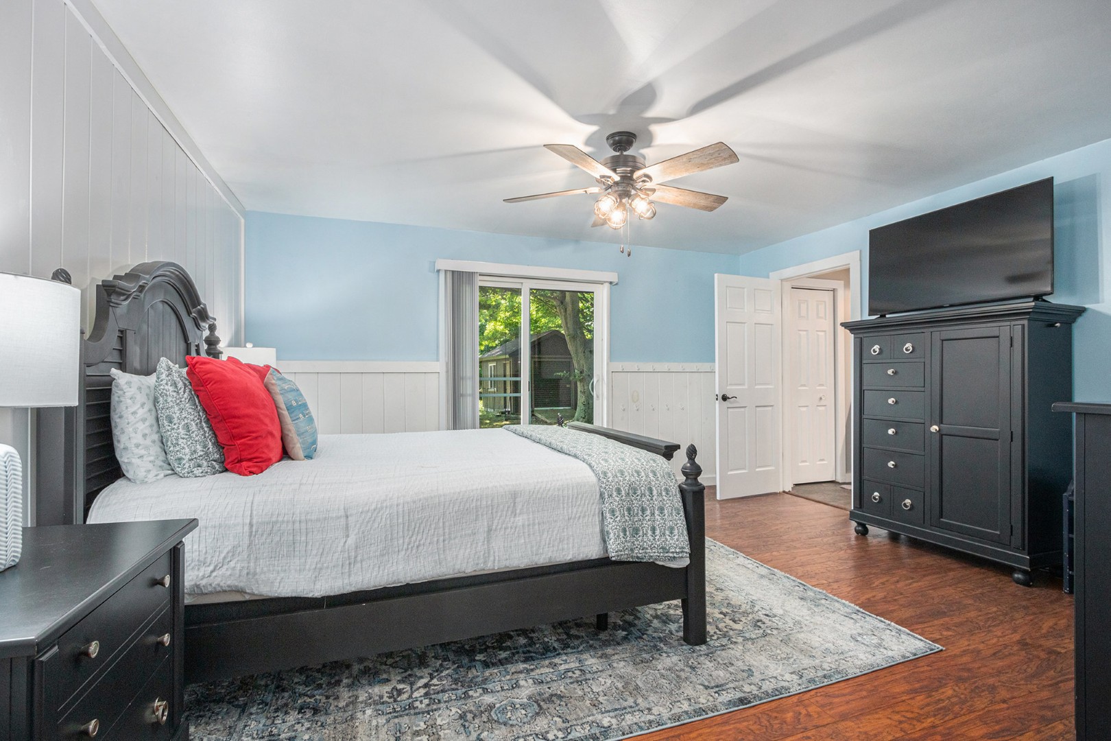 Bright bedroom with blue walls and black furniture