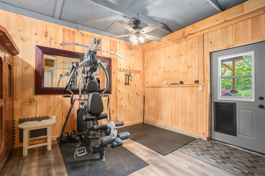 Home gym with wooden walls and exercise equipment