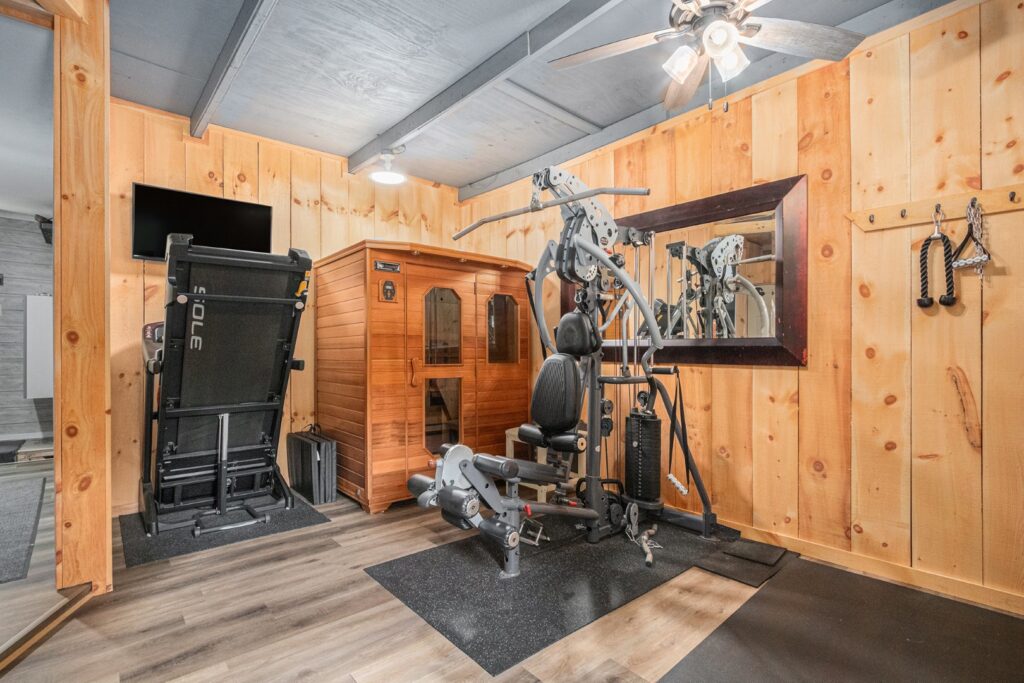 Home gym with treadmill, sauna, and exercise machine