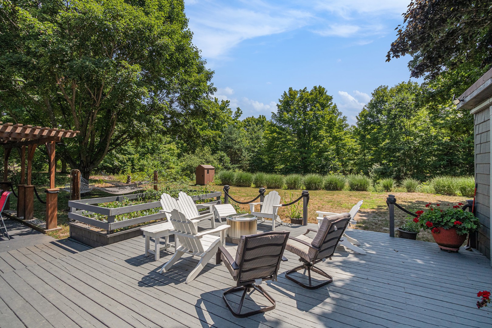 Wood deck patio with chairs and garden view