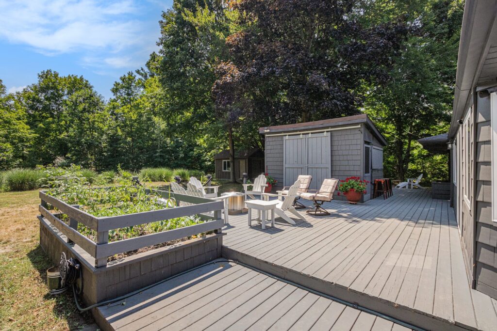 Spacious backyard deck with seating and garden