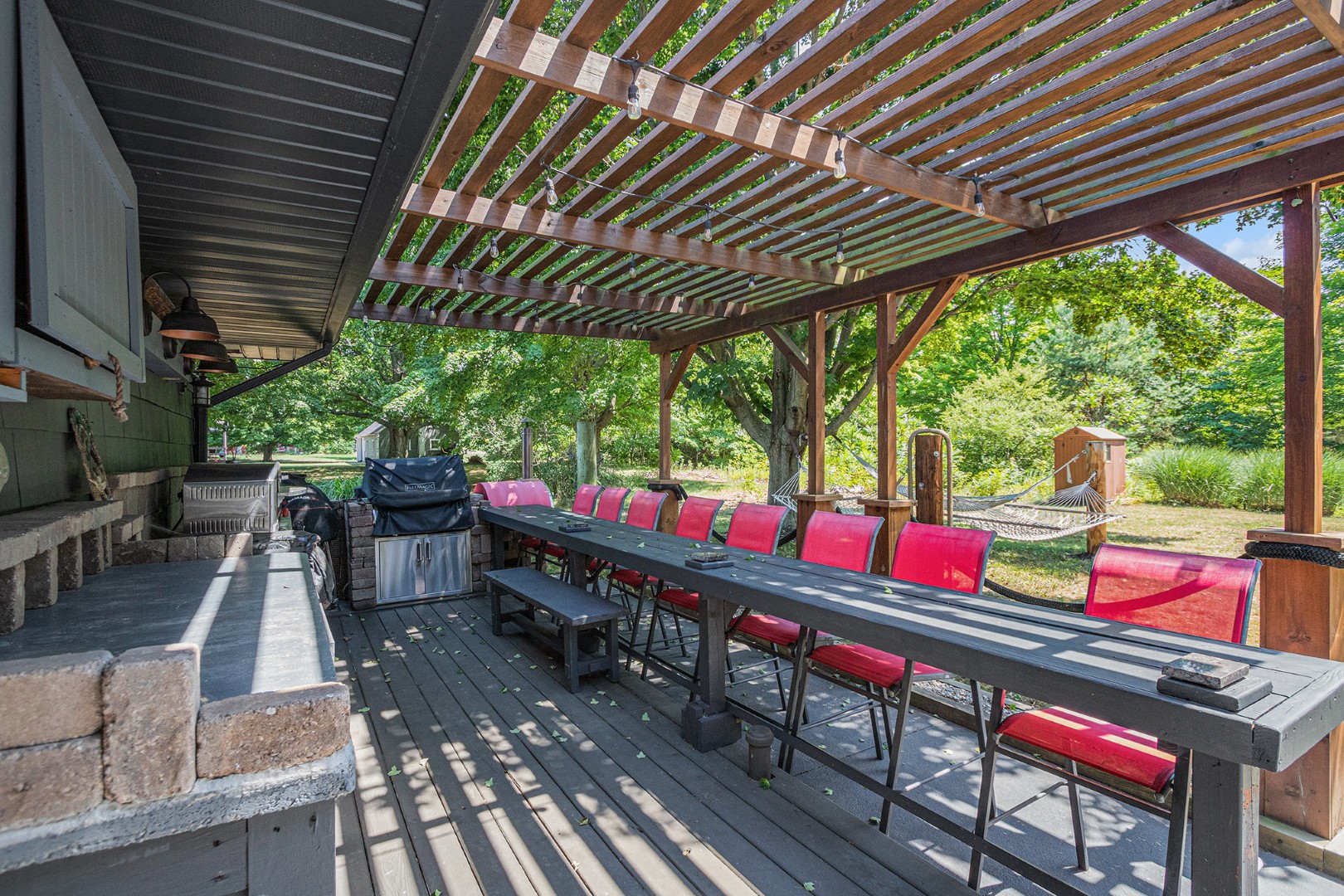 Outdoor patio with grill and red chairs