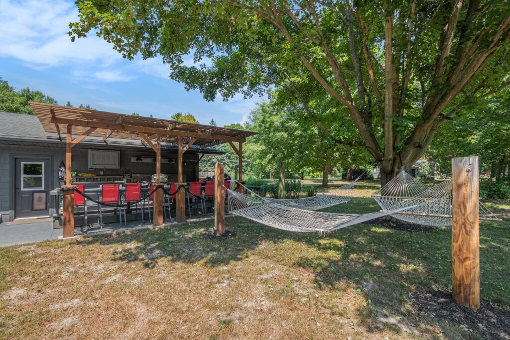 Backyard patio with bar seating and hammocks
