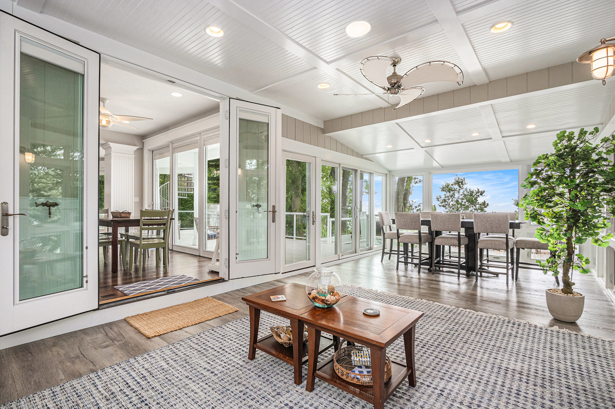 Bright sunroom with large windows and modern furniture