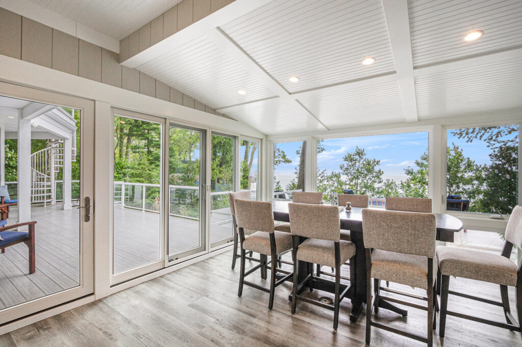 Bright dining room with large windows and deck view