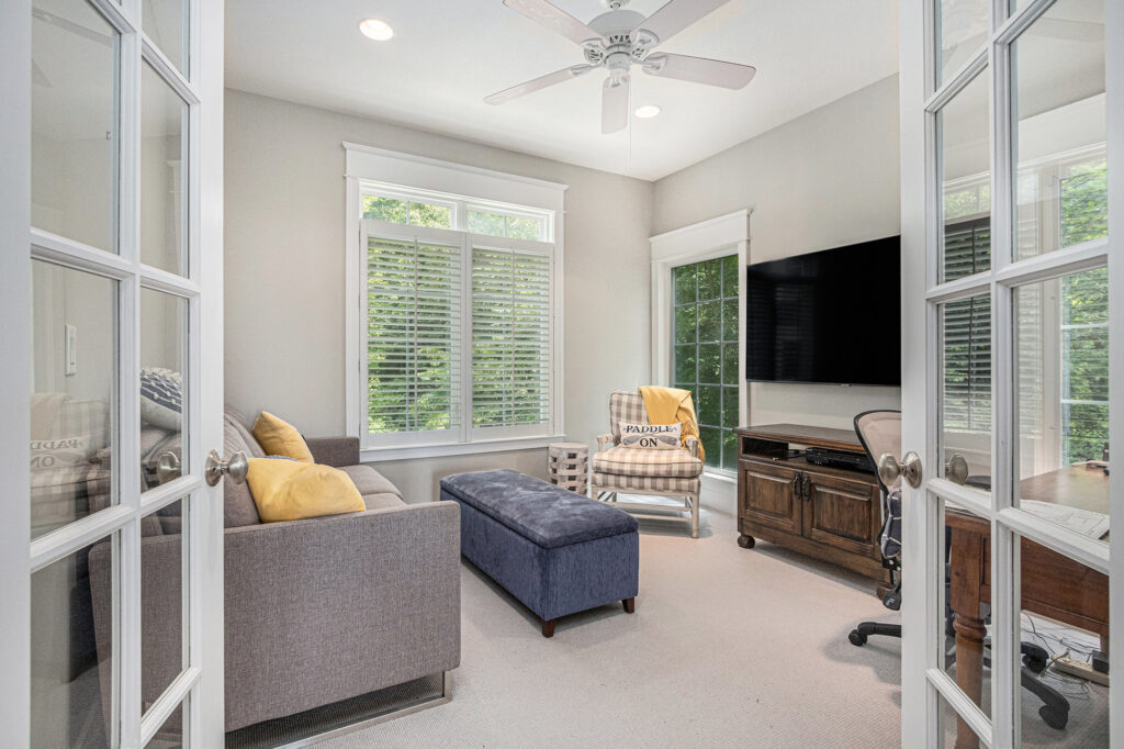 Bright home office with TV and sofa