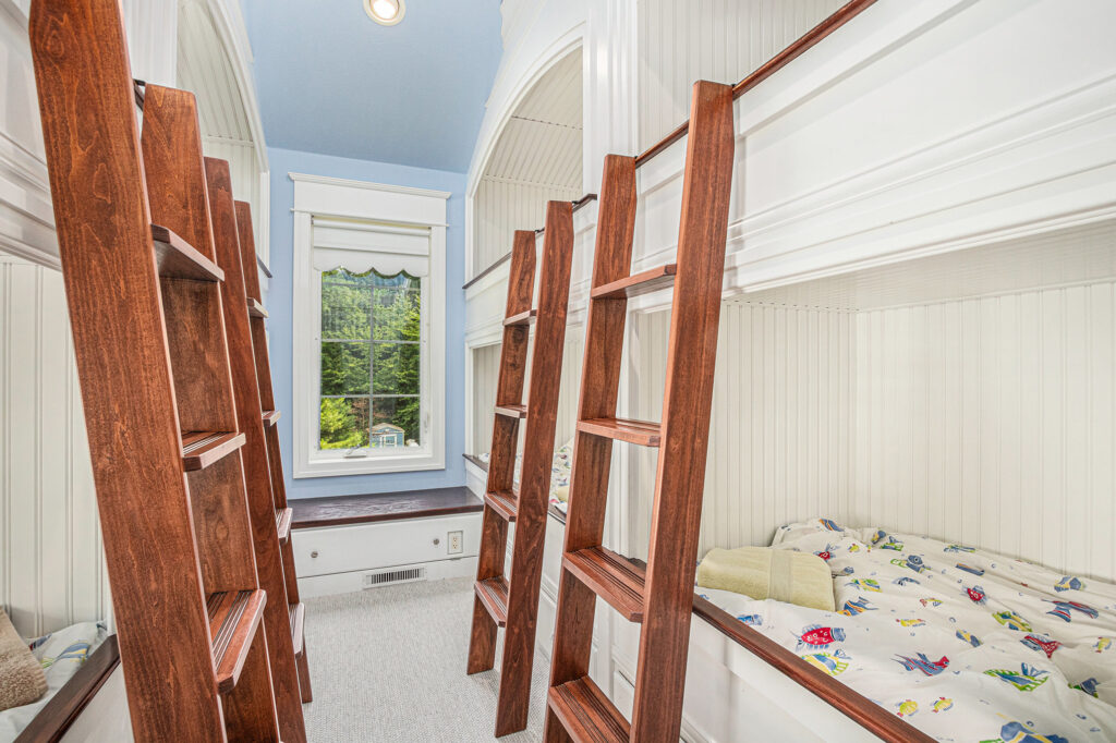 Cozy bedroom with wooden bunk beds and window view