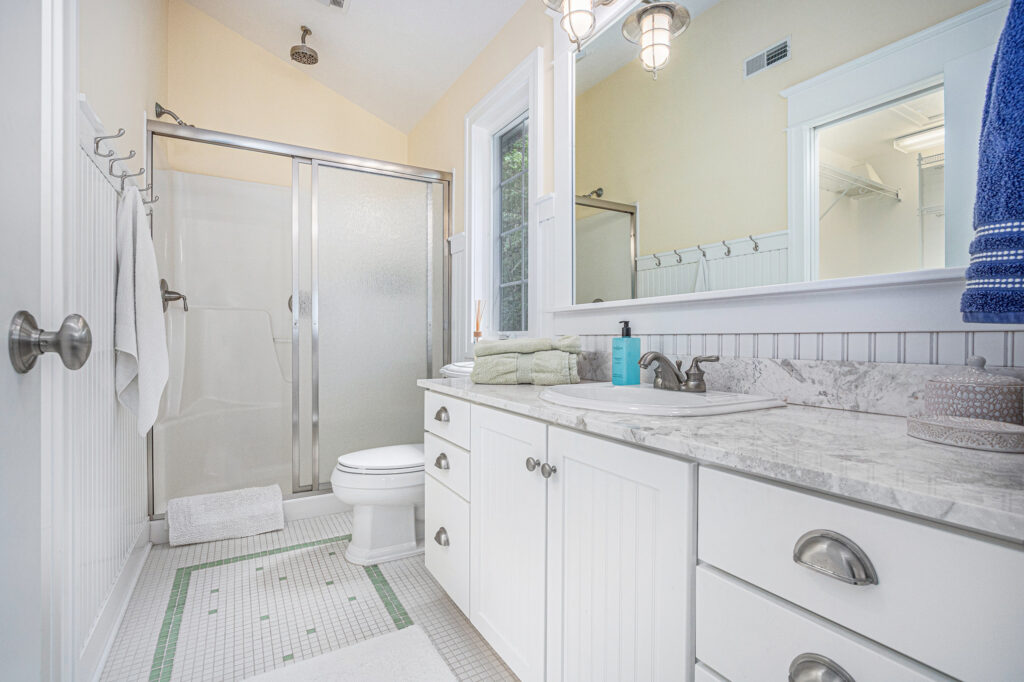 Bright bathroom with shower and marble countertop