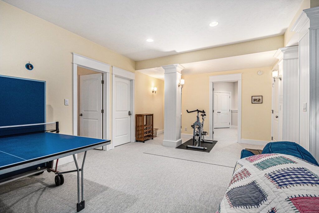 Basement room with ping pong table and exercise bike