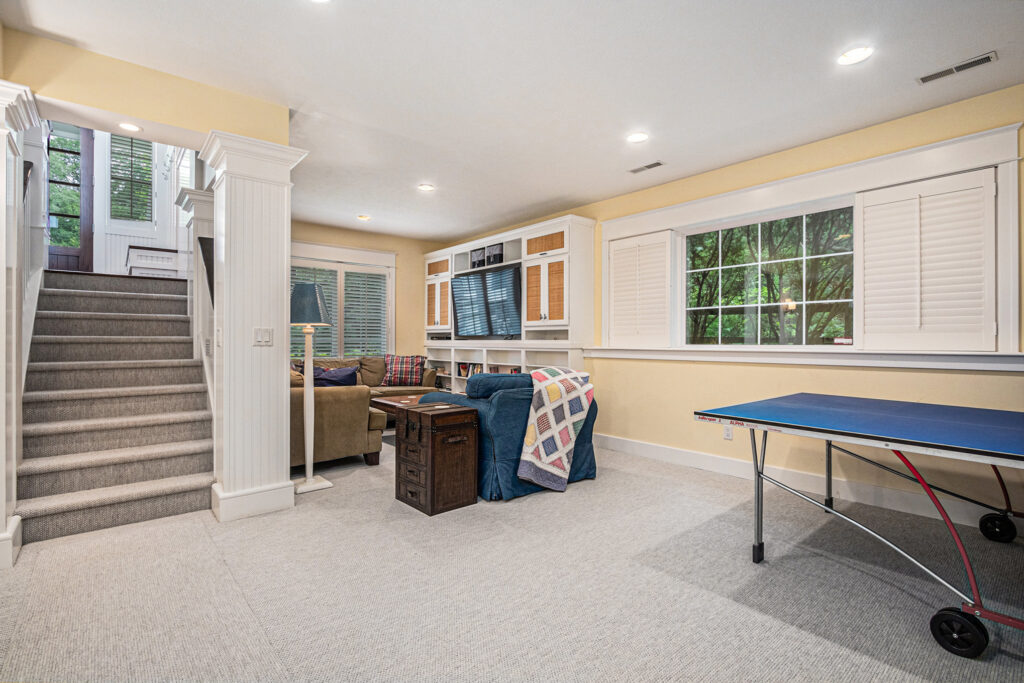 Cozy basement recreation room with TV and ping pong