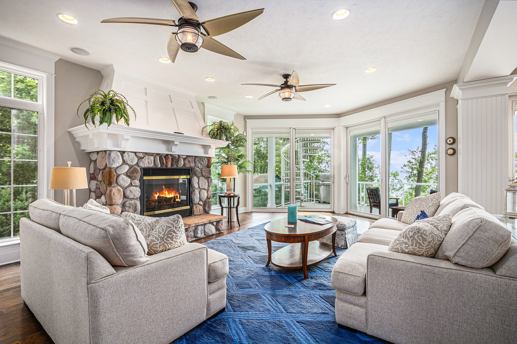 Bright living room with fireplace and lake view
