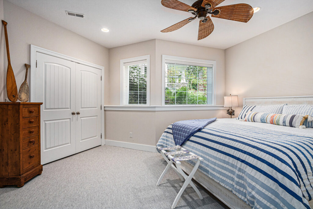 Cozy bedroom with striped bedding and window view