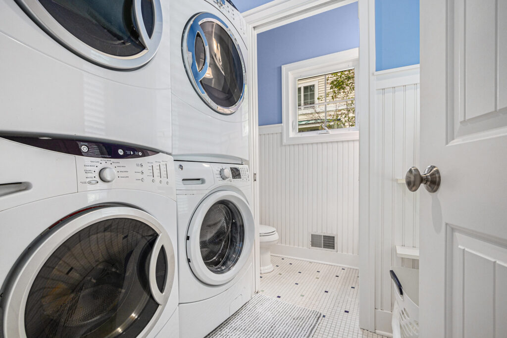 Laundry room with stacked washer and dryer