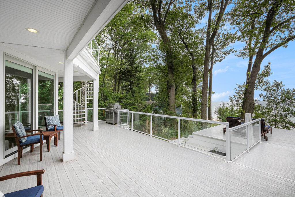 Spacious deck overlooking trees and water view